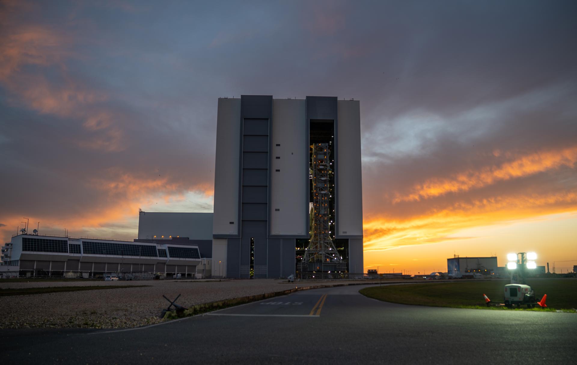 This image shows NASA’s SLS (Space Launch System) and Orion spacecraft rolling out of the Vehicle Assembly Building at NASA’s Kennedy Space Center. NASA's massive Crawler-Transporter, upgraded for the Artemis program, carries the powerful SLS rocket and Orion spacecraft on the Mobile Launcher from the Vehicle Assembly Building to Launch Pad 39B at Kennedy Space Center in preparation for the Artemis II mission. 